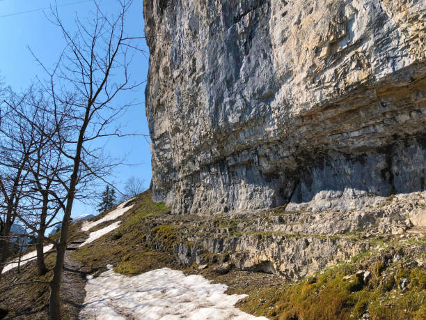 penhasco de äscher ou äscher-felsen (aescher-felsen ou ascher-felsen) na escala de montanha de alpstein e na região de appenzellerland - ascher - fotografias e filmes do acervo