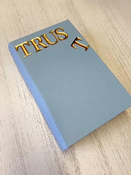 fake book with text trust on cover, fallen t - in gold we trust imagens e fotografias de stock