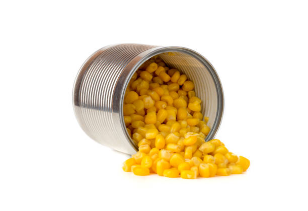 istock Canned corn on a white background. Corn closeup in an iron jar on a white background. 1145910464