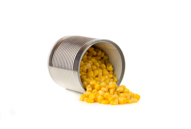istock Canned corn on a white background. Corn closeup in an iron jar on a white background. 1145910472