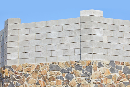 Concrete block bricks in stack for wall construction. Concrete block, cinder blocks, breeze blocks, hollow blocks, Besser blocks or Besser bricks wall background, brick texture