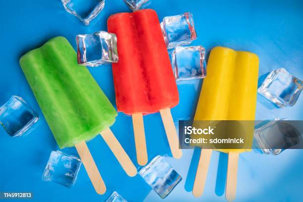 Green Red Yellow Ice Pops On Blue Stock Photo - Download Image Now - Close-up, Cold Temperature, Cube Shape