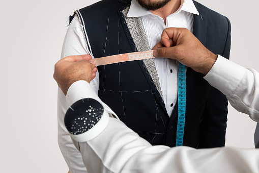 Man Measuring Jacket on Male Dress