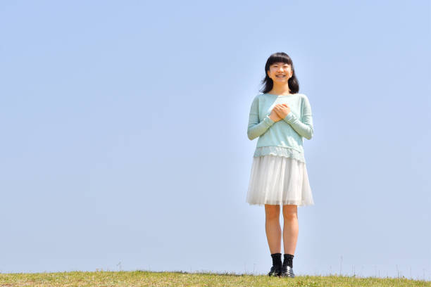 istock Japanese girl smiling in the blue sky 1145913521