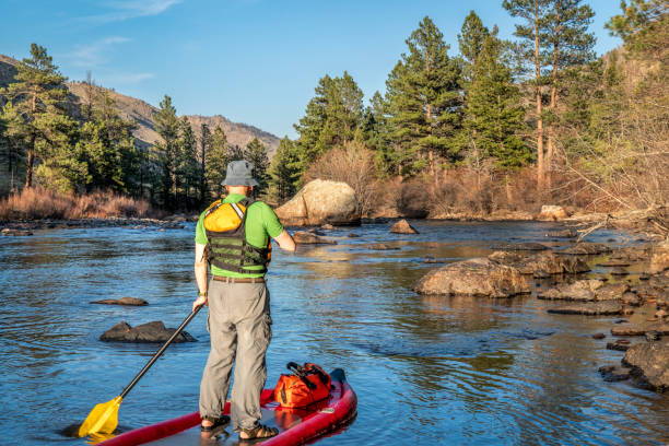 istock stand up paddling on mountain river 1145914990