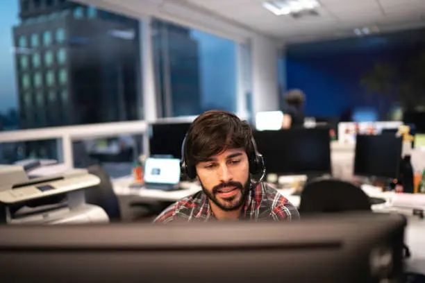 Employee working with headset in office callcenter