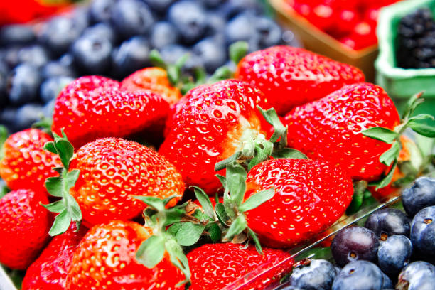 istock Strawberries and different fruits on the background 1145918038