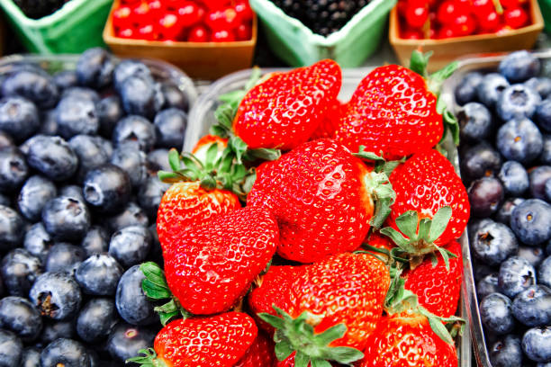 istock Strawberries and different fruits on the background 1145918130
