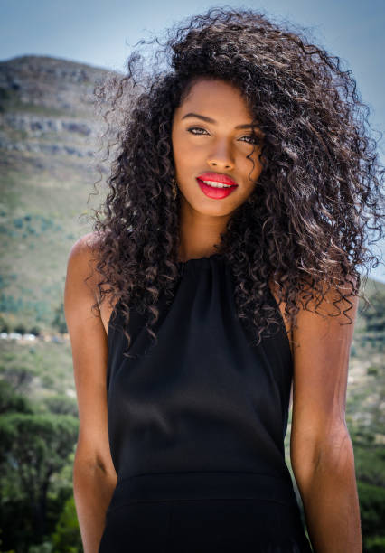 Black woman with red lips looking at camera stock photo