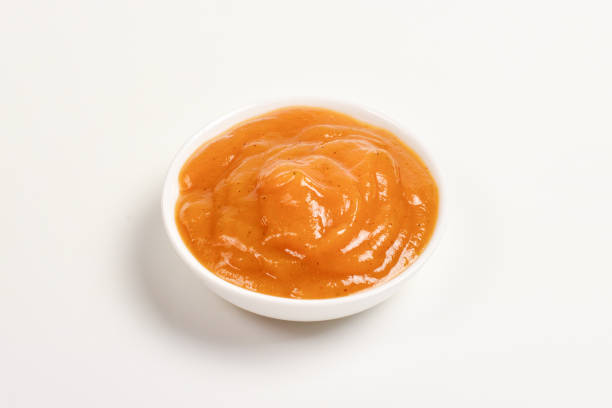istock Orange sauce in white plate on white background. 1145919868
