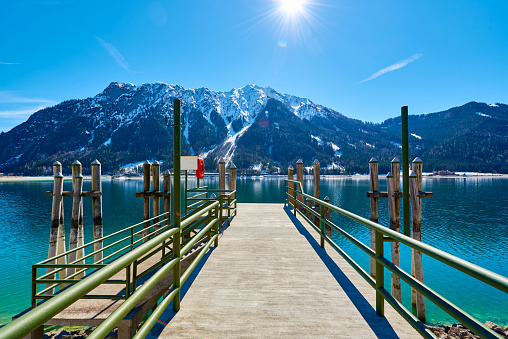 Pier near of lake Achen on a sunny day in the Austrian Alps. Photo taken in Spring.