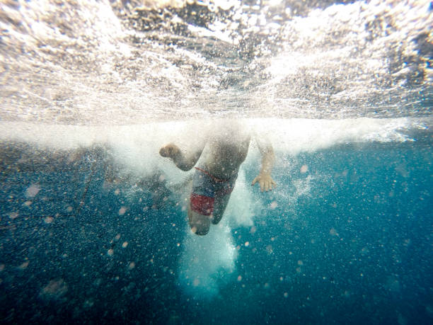 istock Child swims in turbulent ocean water 1145921502