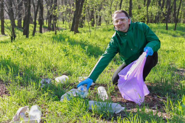 istock A man cleaning forest from the plastic, ecology of the environment, forest 1145923690