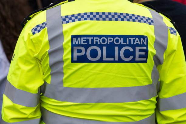 Police Back view of metropolitan police officers jacket. metropolitan police stock pictures, royalty-free photos & images