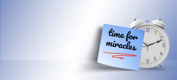 istock motivational concept; time for miracles  message on blue sticky note paper with white alarm clock 1145927987