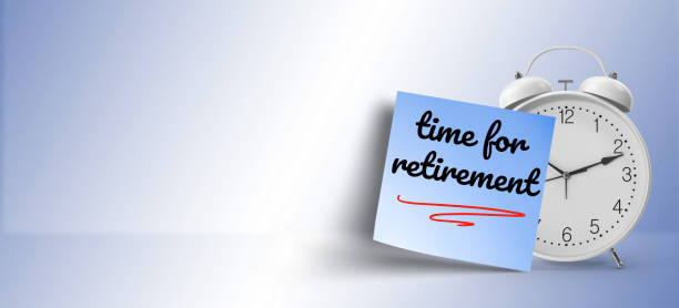 istock motivational concept; time for retirement  message on blue sticky note paper with white alarm clock 1145928017