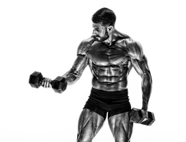 istock Handsome Muscular Men, Bodybuilder Lifting Weights. Black and White Image 1145930287