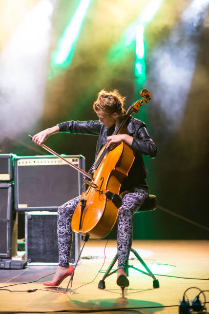istock Young woman playing cello on the stage 1145932981