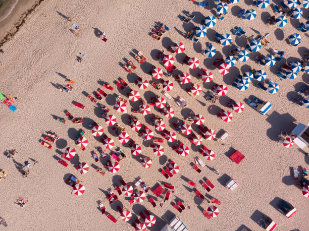 istock Aerial view of crowd sunbathing on the beach 1145933188