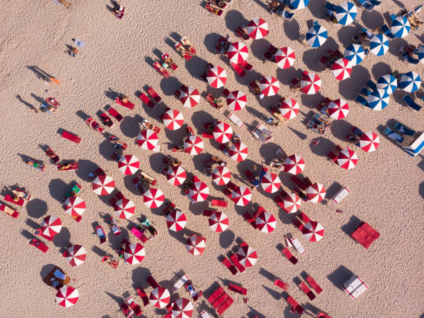 Aerial view of crowd sunbathing on the beach Crowd sunbathing on the beach, South Beach, Florida, USA florida beach above stock pictures, royalty-free photos & images