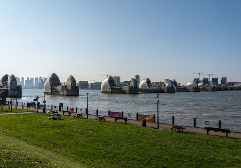 LONDON, UK - 21 APRIL 2019: Tourists watch the Thames Barrier in docklands of London near Greenwich
