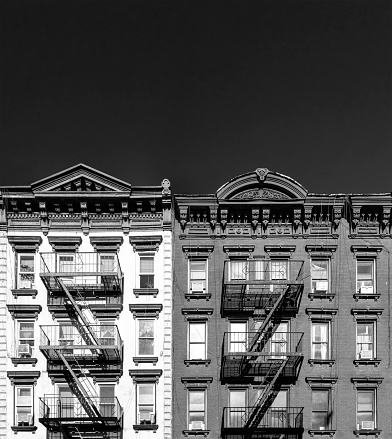 Black and white buildings with empty dark sky background in New York City NYC