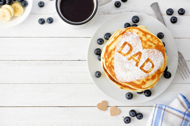 istock Fathers Day pancake breakfast with heart shape and DAD letters, top view corner border on white wood 1145935084