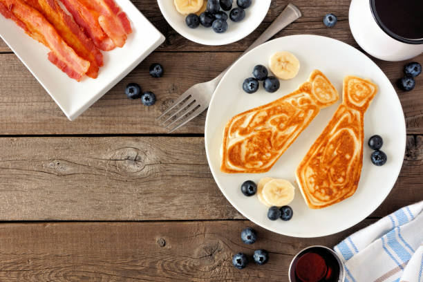 istock Fathers Day tie shaped pancake breakfast, top view corner border on a rustic wood background 1145935943