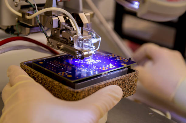 istock Wire Bonder Used for Attaching Silicon Chips and Electronic Devices to a PCB Printed Circuit Board 1145936991