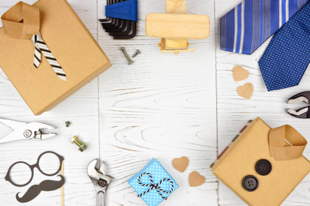istock Fathers Day frame with shirt gift boxes, ties, tools and decor over white wood 1145937723
