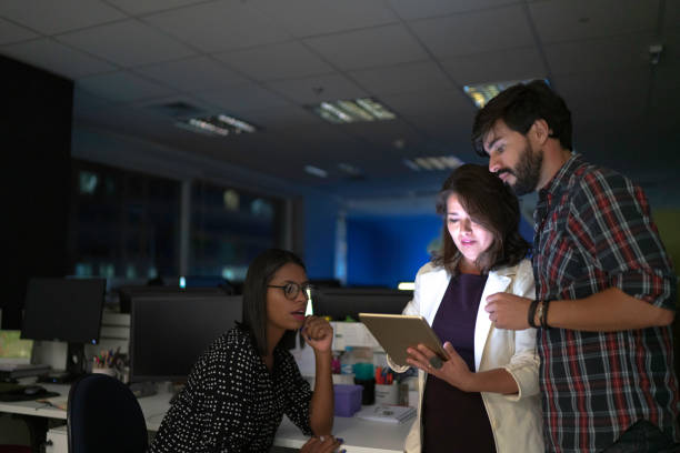 istock Dedicated team reunited working late at office and using tablet 1145938480