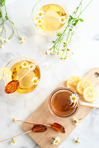 Table set flat lay with honey lemons and, tea honey spoons and chamomile tea