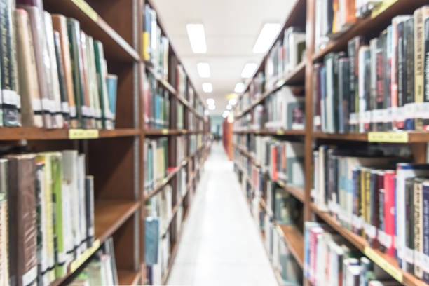 istock Blur school library or study room with book shelves for education background 1145942651