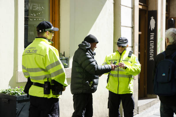 Homeless being checked by policeman