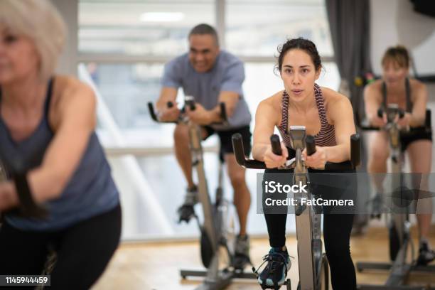 Group Exercise Class Stock Photo - Download Image Now - Exercising, Health Club, Stationary Cycling Class