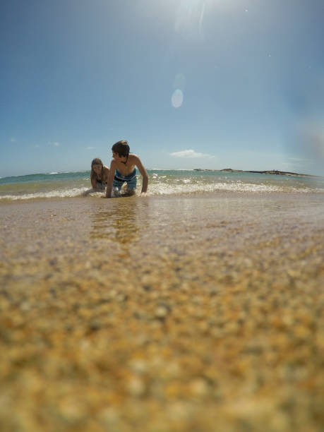 istock Playful mama and son in Hawaii playing in the ocean 1145945087