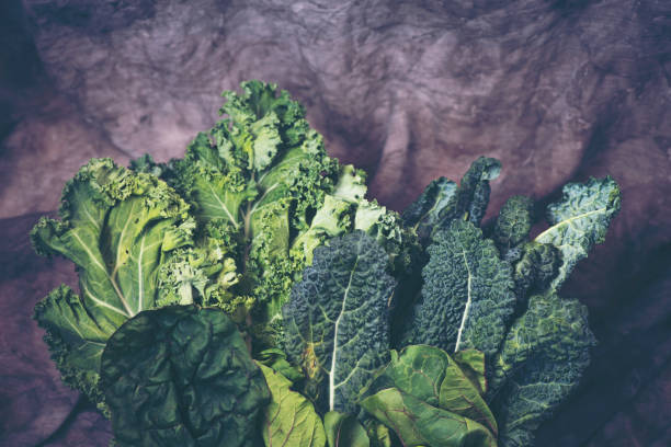 istock Green leafy vegetables on vintage background 1145950672