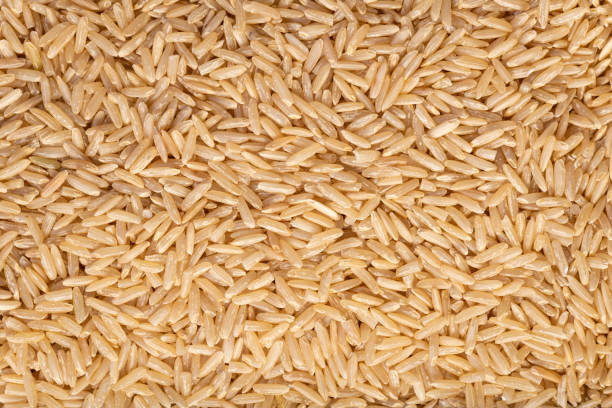 sfondo texture riso marrone - brown rice rice healthy eating organic foto e immagini stock