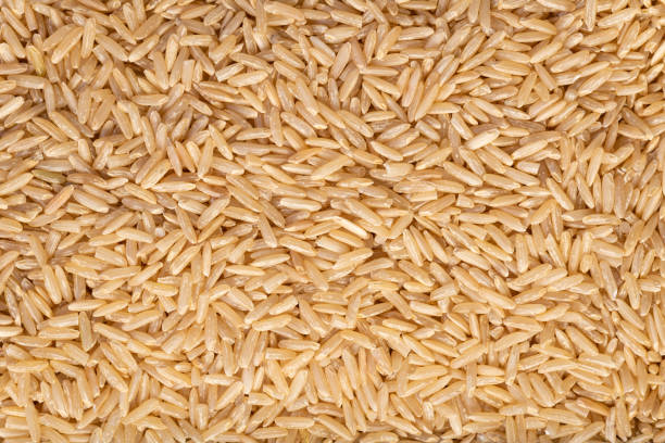 玄米の質感の背景 - brown rice rice healthy eating organic ストックフォトと画像