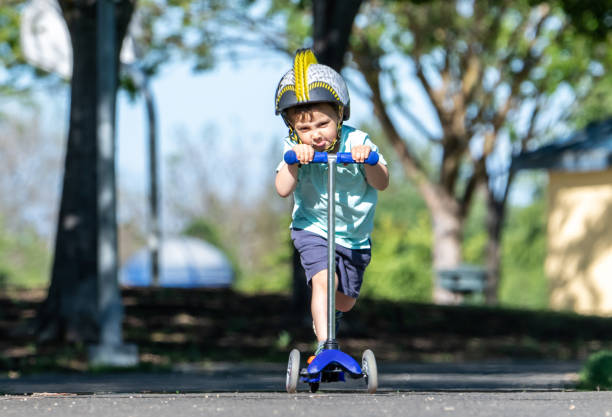 istock Three years old child boy riding his push scooter 1145956194