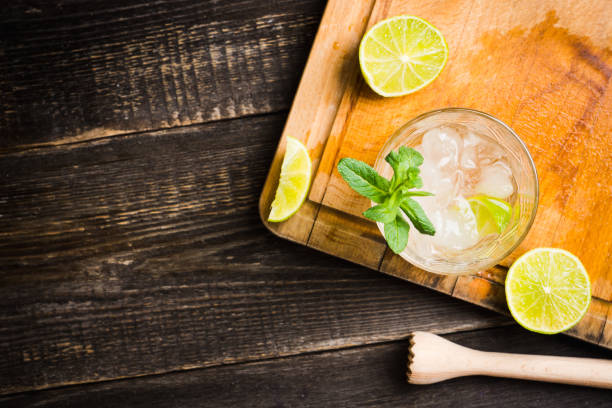 Old fashioned beverage with lime and mint leaves Old fashioned beverage with lime and mint leaves. Selective focus. Shallow depth of field. vodka soda top view stock pictures, royalty-free photos & images