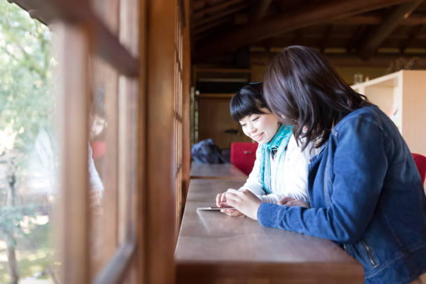 istock Young woman looking at tablet screen in cafe 1145961256