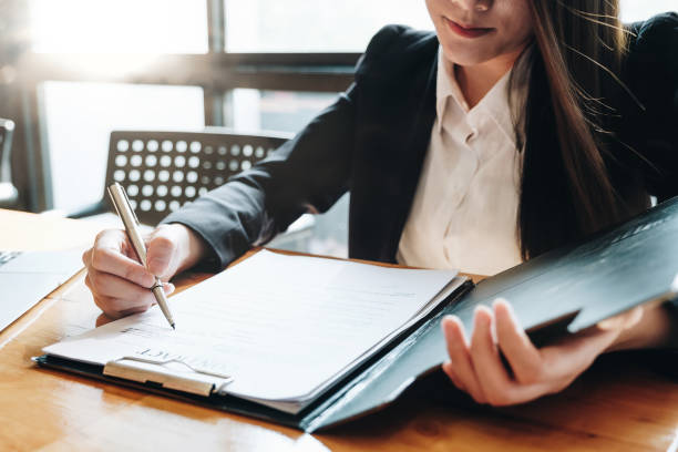 Attractive business woman sign a contract documents agreement with customer to sign contract. Attractive business woman sign a contract documents agreement with customer to sign contract. female lawyer stock pictures, royalty-free photos & images
