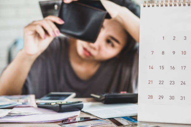 istock stress Asian woman open empty wallet looking for money for debt 1145963592