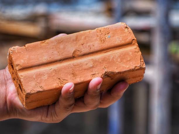 A bricklayer works on a new domestic kitchen extension using reclaimed bricks. Images show general construction and a cross section of the wall revealing insulation and outer and inner skins