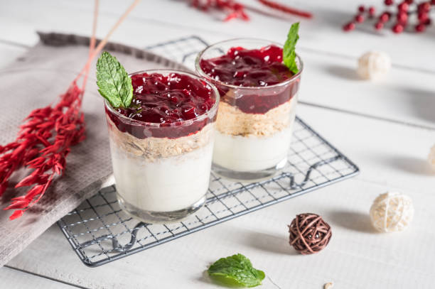 istock Dessert in glass with cream, muesli and berries 1145965578
