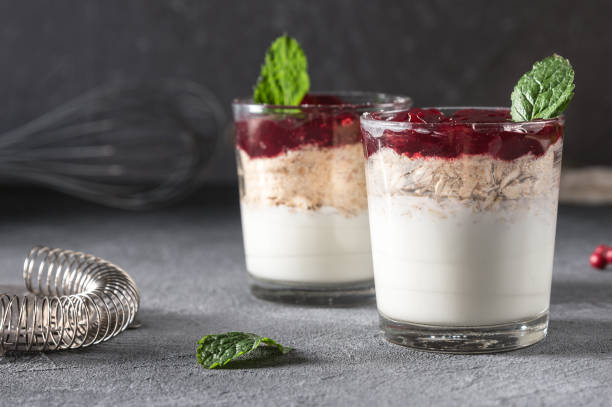 istock Dessert in glass with cream, muesli and berries 1145965597