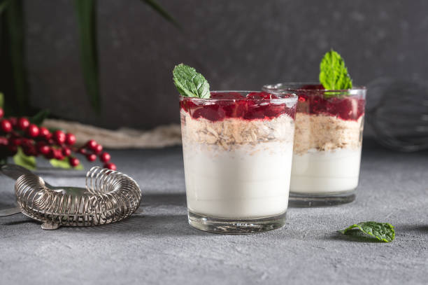 istock Dessert in glass with cream, muesli and berries 1145965598