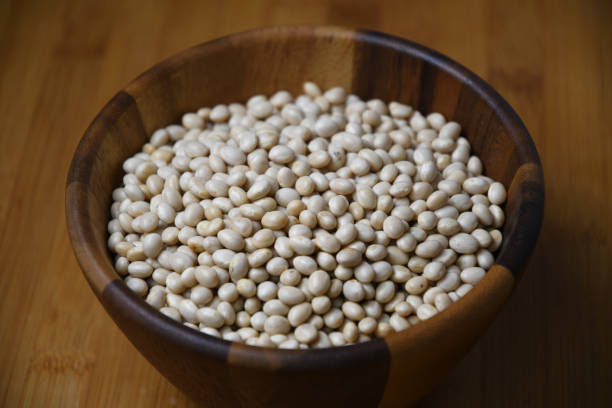 istock Navy Bean, White kidney bean on wooden bowl 1145967912