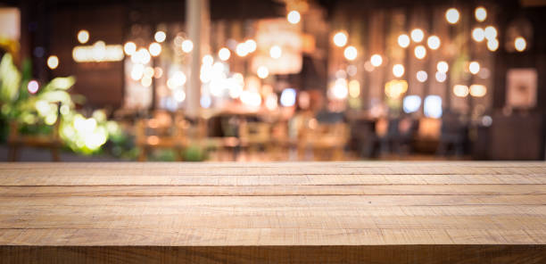 istock Empty wood table top and blur of night pub or restaurant background/selective focus .For montage product display 1145971268